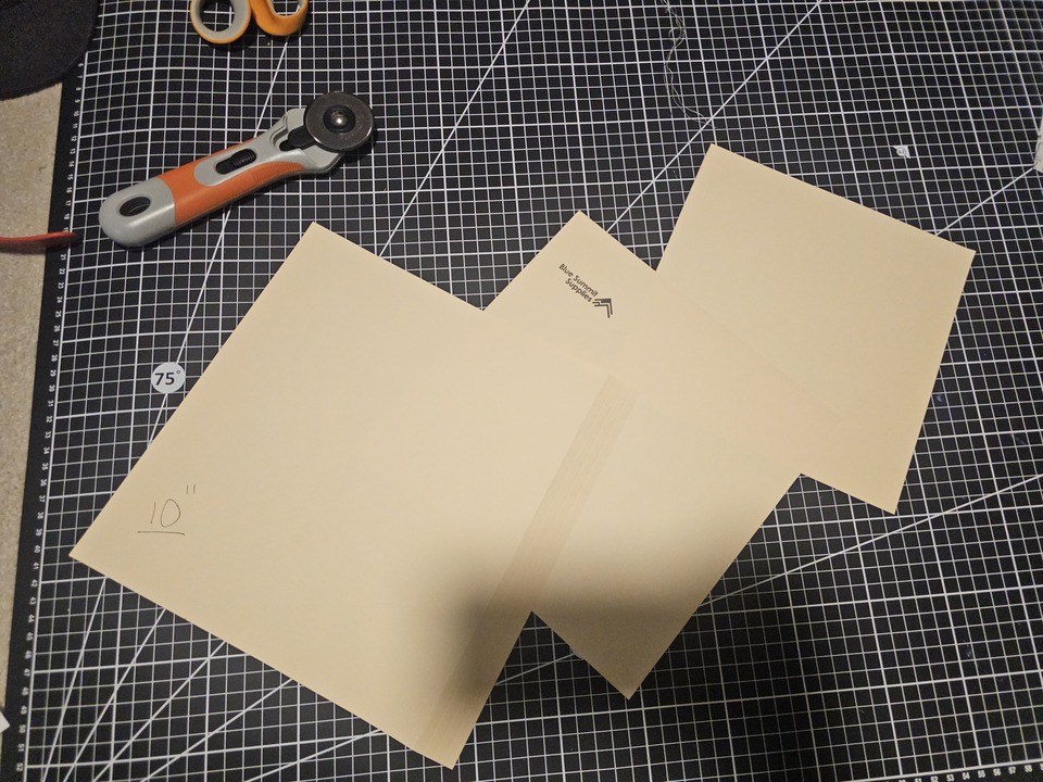 manilla folders cut to 10 9 and 8 square inches, on a flat cutting mat