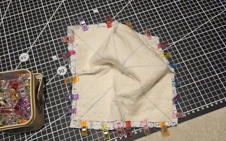 clipped fabric inverted with right sides together, on a cutting mat